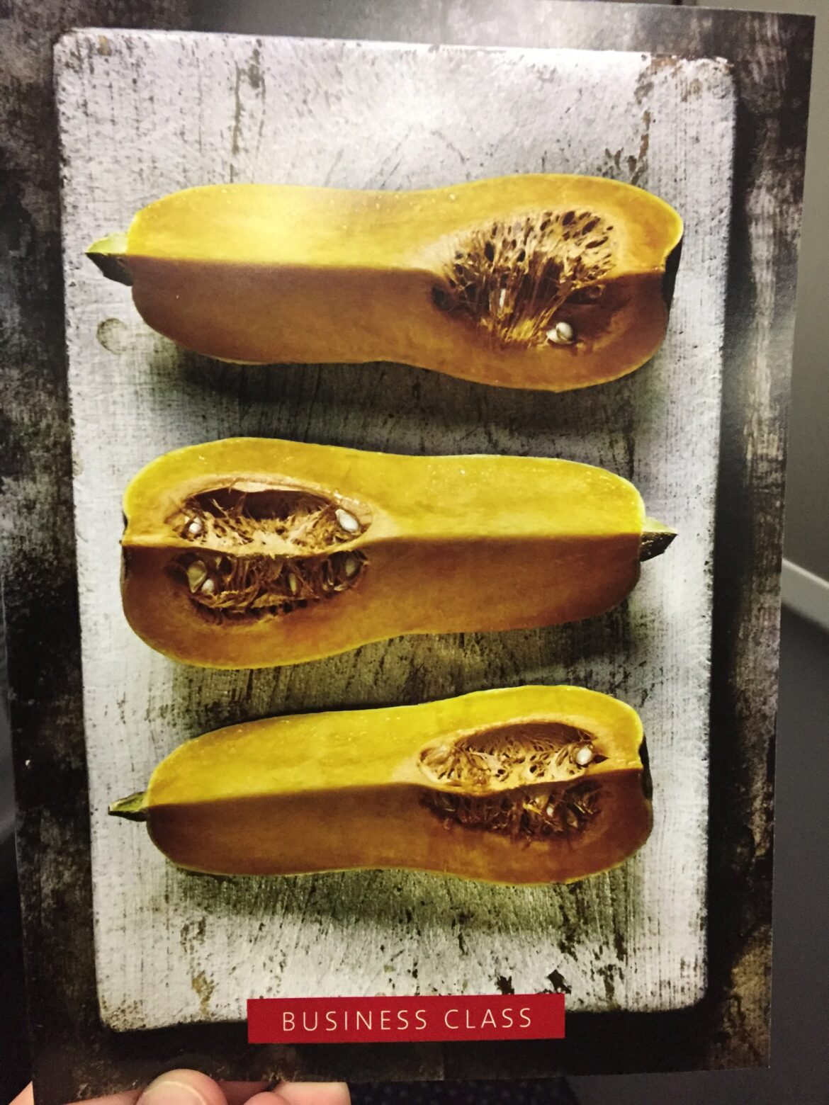 a butternut squash cut in half on a wood surface