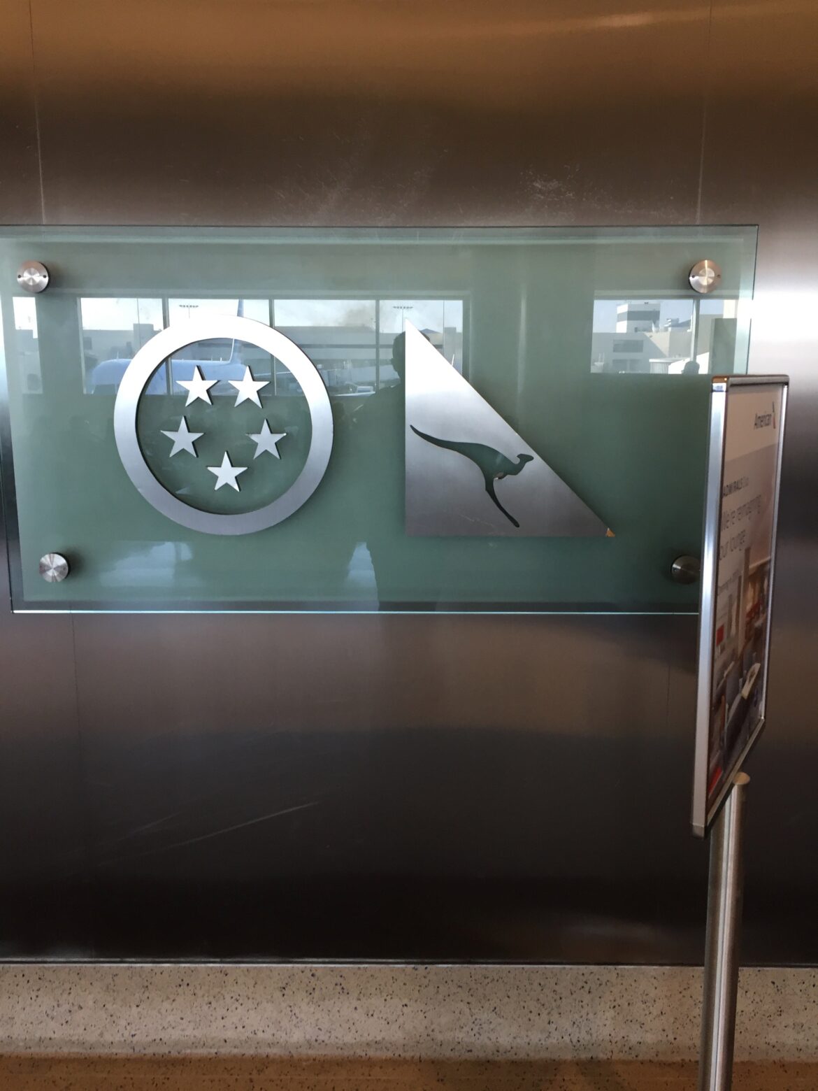 a glass sign with a kangaroo and stars on it