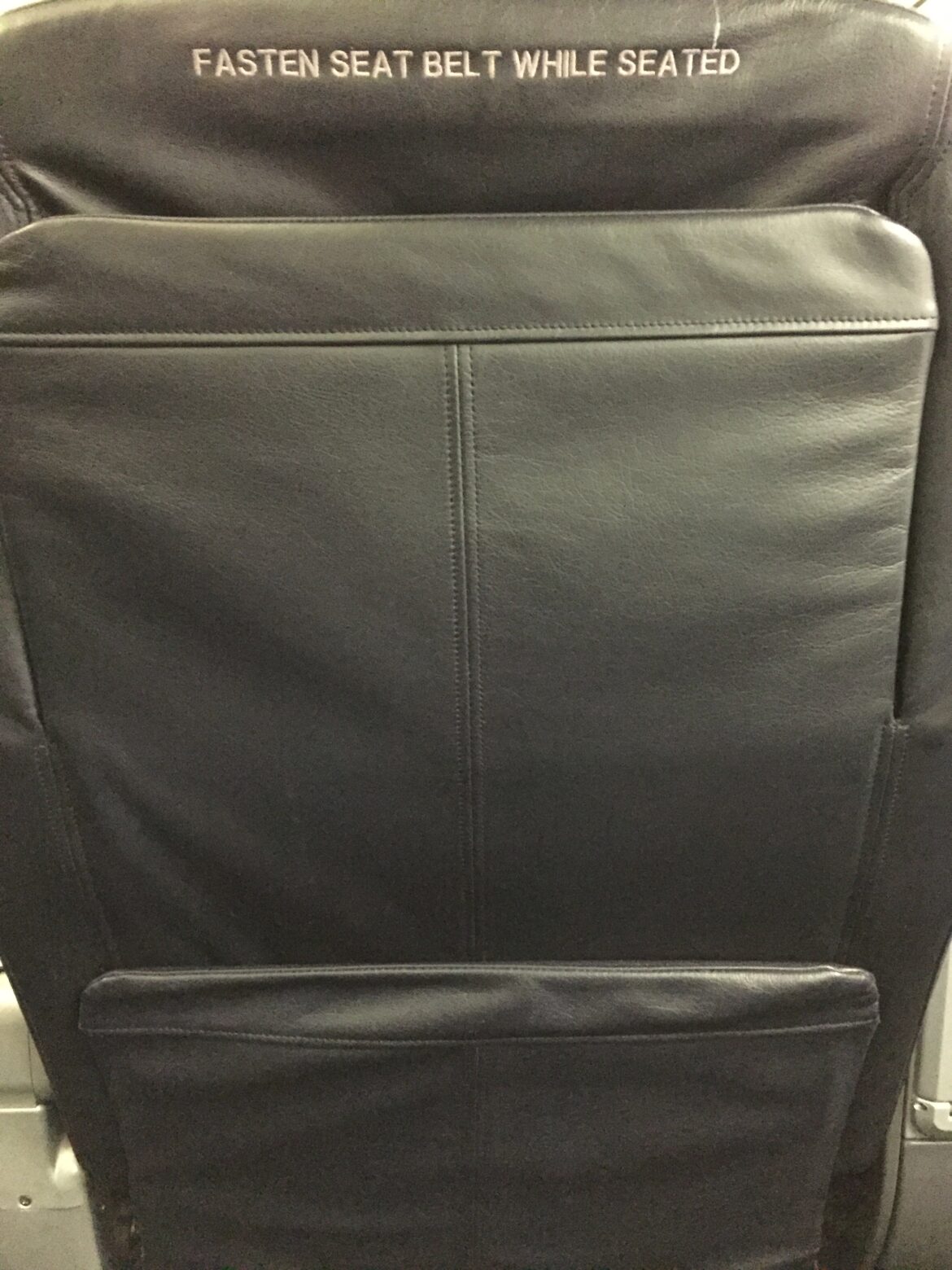 a black leather chair with pocket