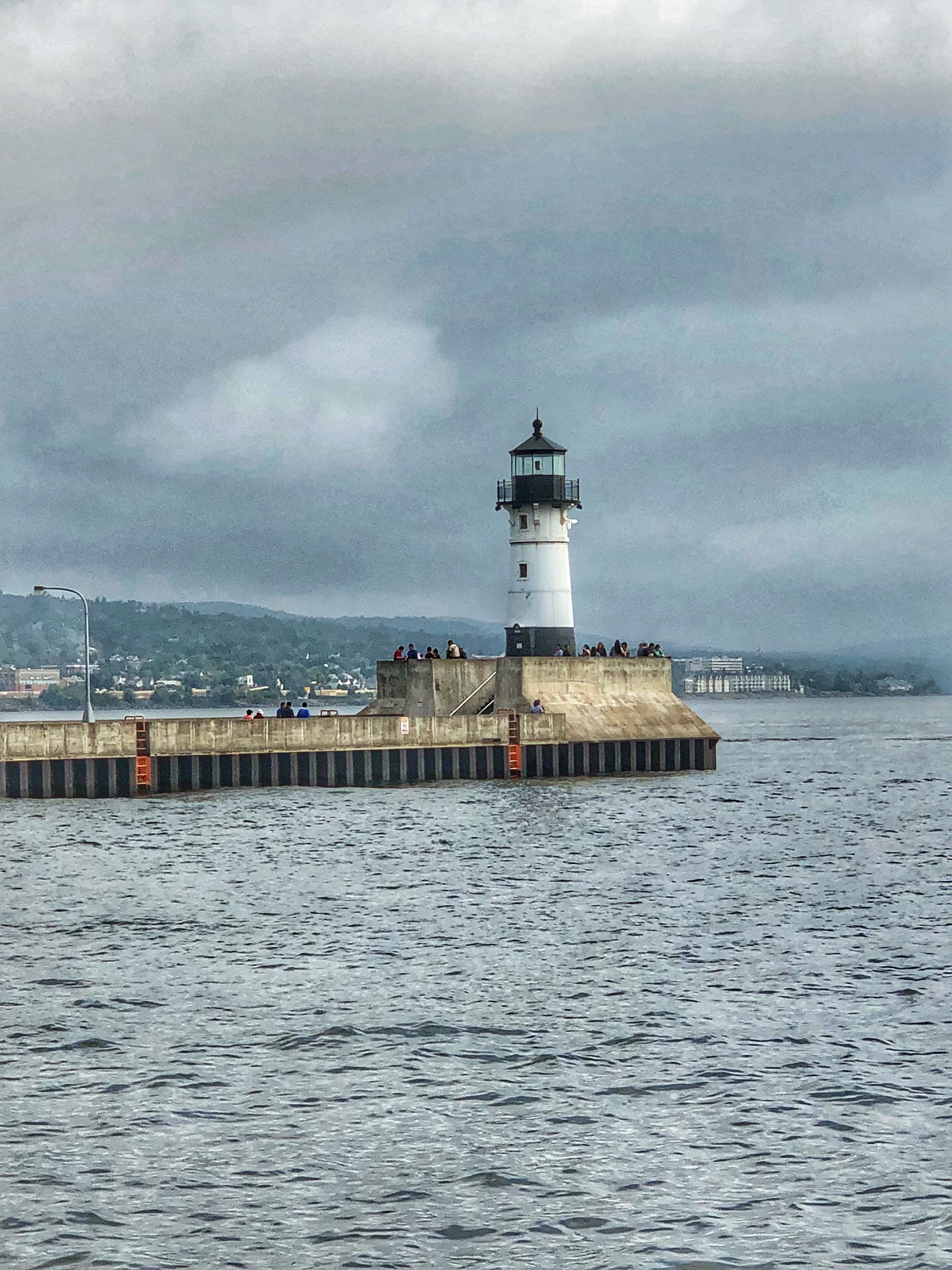 a lighthouse on a dock in the water