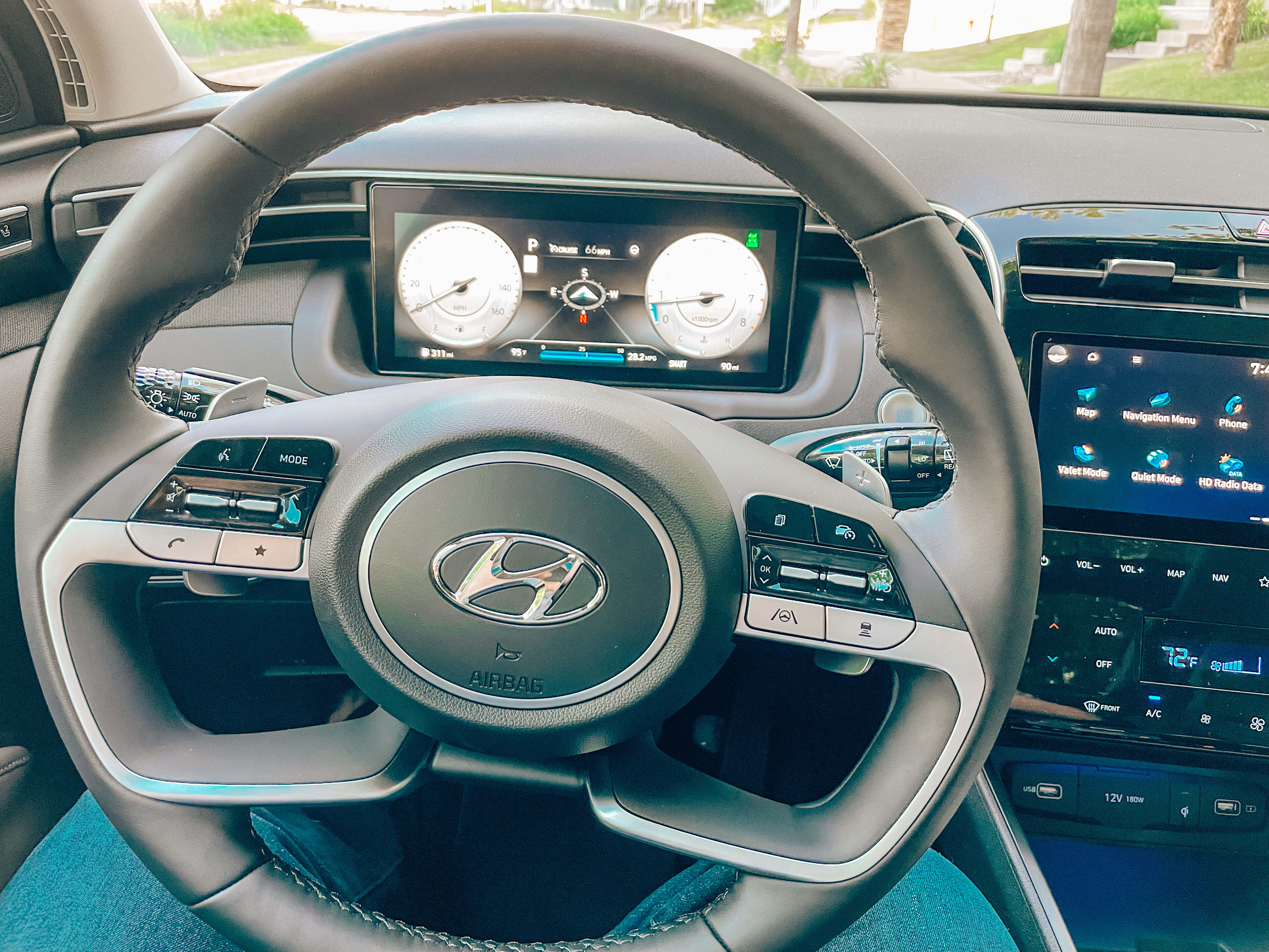 the steering wheel and dashboard of a car