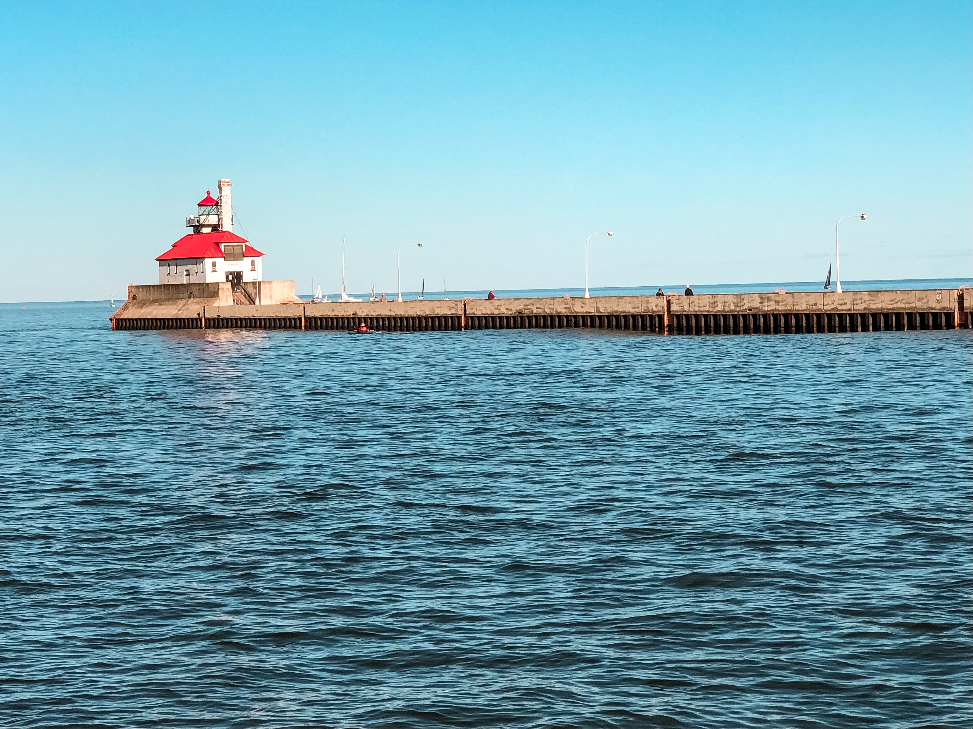 a lighthouse on a pier in the water