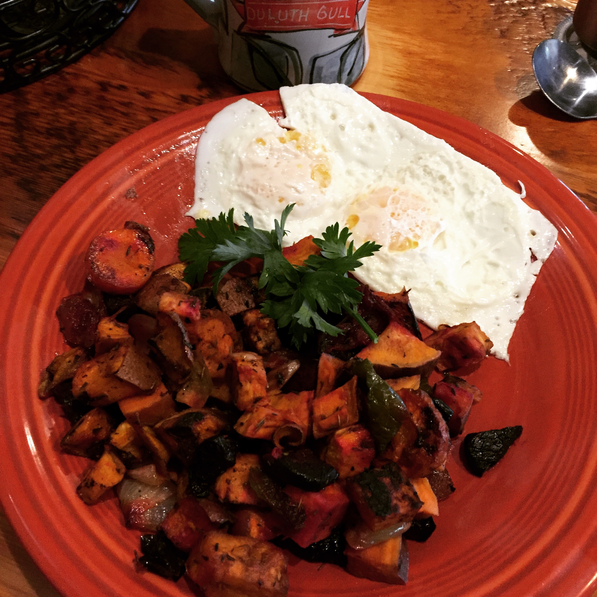 a plate of food with two eggs and a cup of coffee