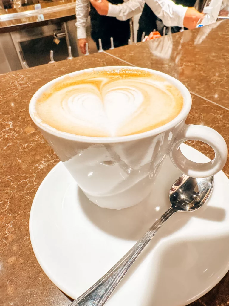 a cup of coffee with a heart shaped foam in it
