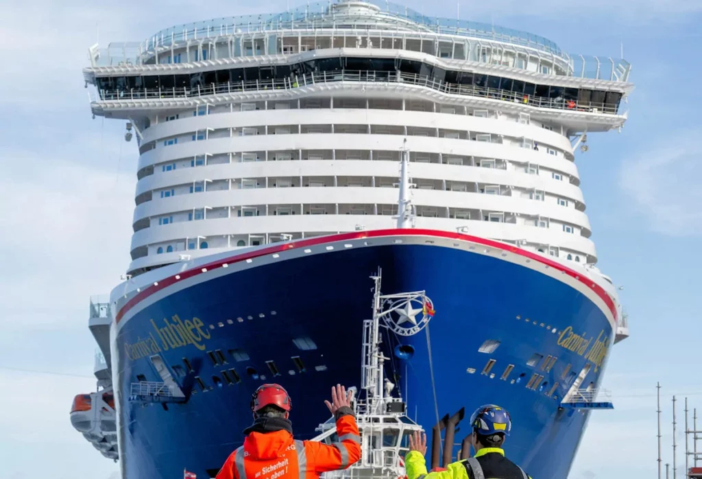 Carnival Jubilee with tug boat