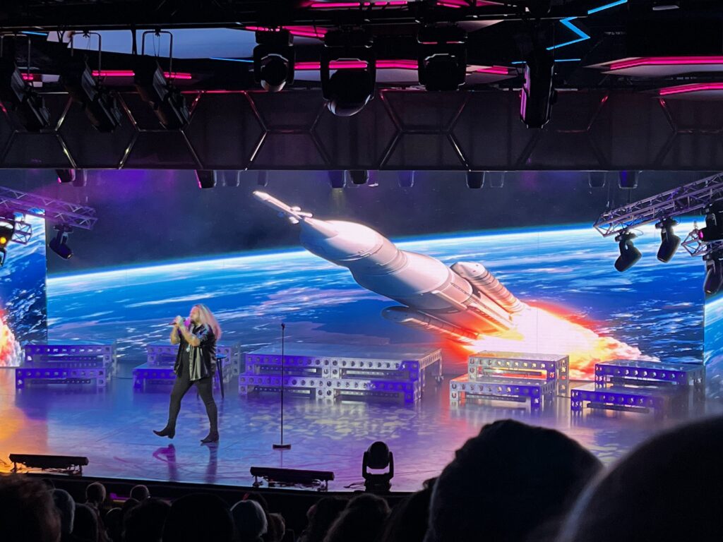 a person on stage with a rocket on the stage