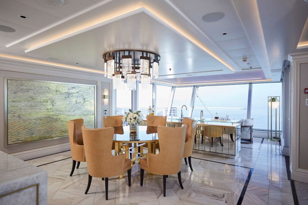 a dining room with a table and chairs - Regent Seven Seas World Cruise 2027