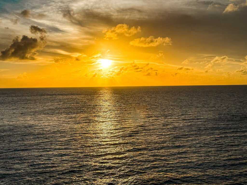 Sunset over the ocean on Utopia of the Seas